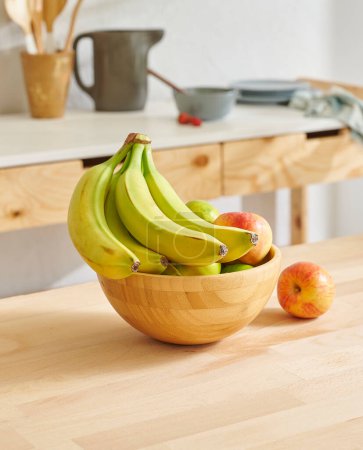 Photo for Close up fruit basket on the wooden table, kitchen background, banana, apple and pear. - Royalty Free Image