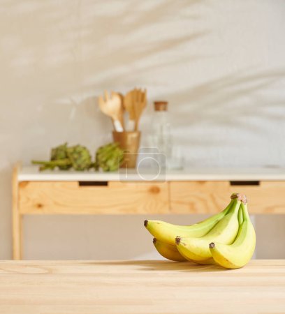 Photo for Banana on the wooden table and kitchen background style. - Royalty Free Image