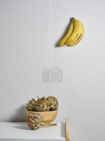 Photo for Yellow banana kitchen style, wooden table and vegetables. - Royalty Free Image