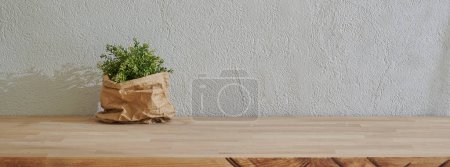 Photo for Vase of plant in front of the grey stone wall, wooden table style. - Royalty Free Image