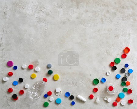 Photo for Plastic bottles and caps are on the green table, recycling waste concept. - Royalty Free Image