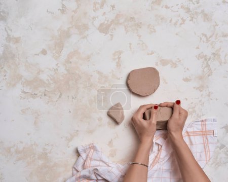 Photo for Ceramic making, woman hand, brushes and tools, marble background. - Royalty Free Image