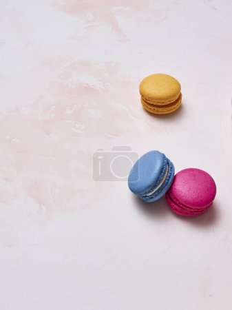 Photo for Colorful macaroon on the decorative table style and background, hand and plate style, up view. - Royalty Free Image