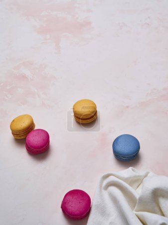 Photo for Colorful macaroon on the decorative table style and background, hand and plate style, up view. - Royalty Free Image