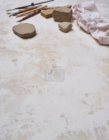 Photo for Making ceramic, women's hands and tools on the decorative table style background, up view. - Royalty Free Image