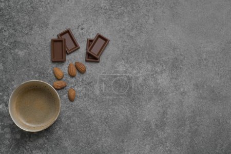 Photo for Ceramic glass coffee style, chocolate and almond on the stone table background, grey decorative styling. - Royalty Free Image