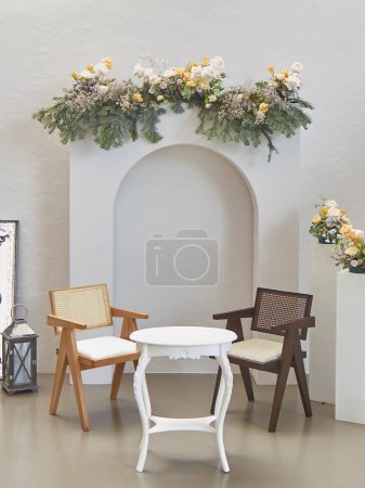 Photo for Engagement organization decoration interior style, chair table room and modern flowers detail. - Royalty Free Image