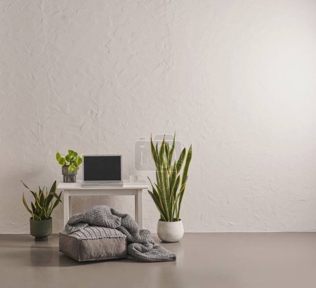 Téléchargez les photos : Fond et plancher de mur en pierre grise, vase de plante verte, bureau, ordinateur portable et cadre. - en image libre de droit