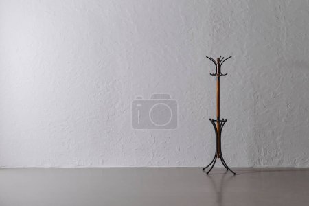 Photo for Standing hanger is in front of the grey stone wall concept, home design. - Royalty Free Image
