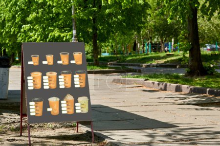 Téléchargez les photos : Panneau d'affichage avec boissons chaudes et froides dans une rue d'été - en image libre de droit