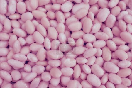 Pink abstract beans, sweet candies, pebbles, backdrop                               