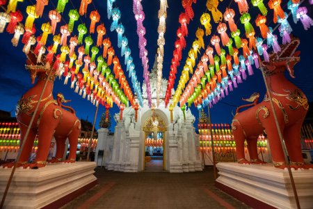 Photo for Lamphun Lantern Festival at Buddhist worship of Phra That Hariphunchai Temple in Lamphun, Thailand. The light of the Festival Lanna lamp lantern in Loi Krathong or Yi Peng Festival - Royalty Free Image