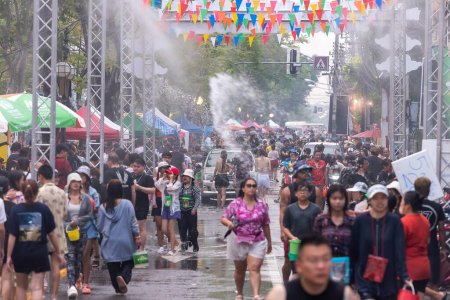 Foto de CHIANG MAI, TAILANDIA - 15 DE ABRIL DE 2023: Los tailandeses y los turistas se divierten salpicando agua alrededor de la calle anualmente Chiang mai Songkran festival, Tailandia. - Imagen libre de derechos