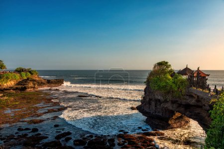 Photo for Pura Batu Bolong is the traditional Balinese temple located on a rocky, in the Tanah Lot area, Bali, Indonesia. It a Hindu Temple on the Beatiful Rock - Royalty Free Image