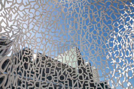 Modern art installation by spanish artist jaume plensa displayed under blue sky in zaragoza