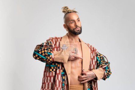 Trendy black latin gay man in fashionable clothes looking away isolated on white background studio portrait People lifestyle fashion lgbtq concept
