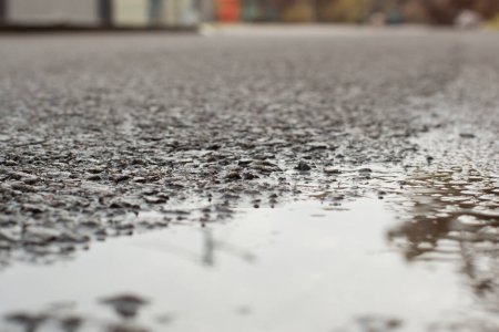 Photo for Stagnant pool of water scene after rain at the suburb asphalt street - Royalty Free Image