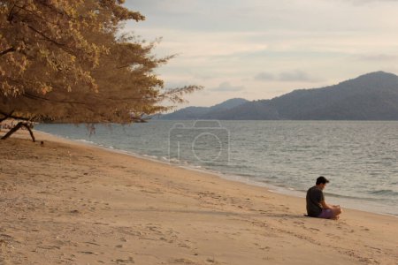 Photo for Perak, Malaysia. December 31,2022: Infrared image of leisure activity of people during cooling evening along the beach at Teluk Senangin. - Royalty Free Image