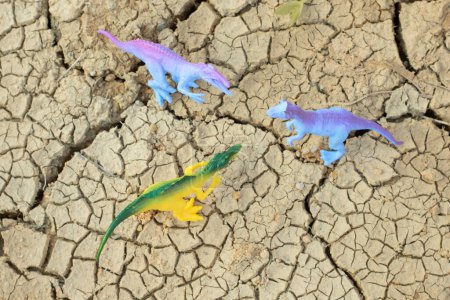 Téléchargez les photos : Image infrarouge des jouets de dinosaures illustrant le vagabondage autour de la terre séchée. - en image libre de droit