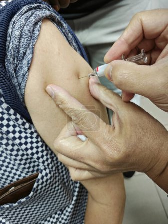 image of someone getting vaccinated on the upper arm.