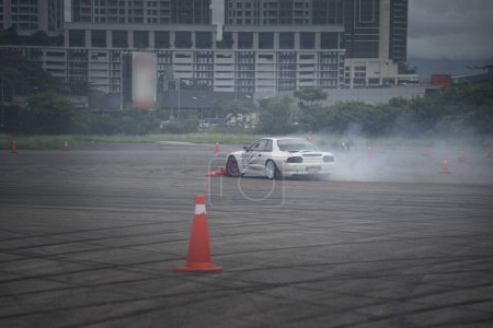 Photo for Distance scene of amateur driver practicing car drifting. - Royalty Free Image
