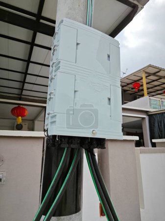 Escena de la caja de utilidad Unifi USW Flex al aire libre junto al poste de la calle.