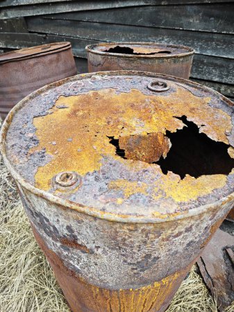 Photo for Abandoned empty and rusty metal barrel left at the junkyard. - Royalty Free Image