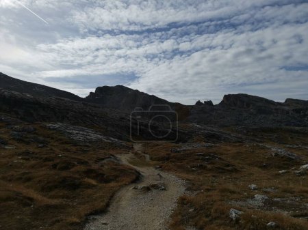 Photo for Beautiful sunny day in Dolomites, blue sky, white clouds, high mountains. Trek to the summit Sass da Ciampac (2667 m). - Royalty Free Image