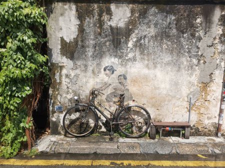 Photo for Street art of a boy and girl on a bicycle, georgetown, penang, malaysia - Royalty Free Image