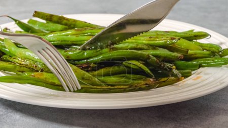 Pan fried French green beans (Haricots Verts) recipe. String beans close-up on a plate