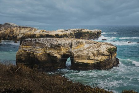 A dramatic beauty of a coastal landscape, with rugged cliffs, and crashing waves. Montana de Oro, California Central Coast