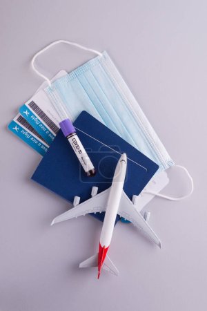 Trendy travel accessories, documents, dollars, passports, boarding pass tickets, sanitizer, and protective face mask. Traveling during coronavirus COVID-19 pandemic