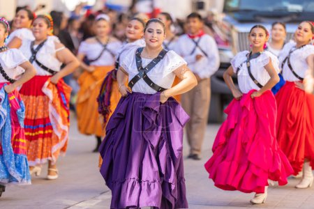 Photo for Matamoros, Tamaulipas, Mexico - November 26, 2022: The Desfile del 20 de Noviembre, Dancers dress up as adelitas performing at the parade - Royalty Free Image