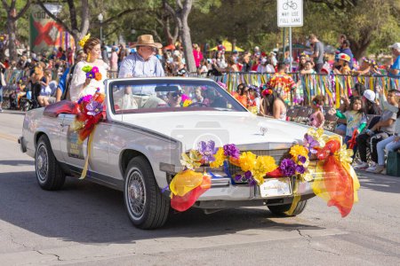 Photo for San Antonio, Texas, USA - April 8, 2022: The Battle of the Flowers Parade, Cadillac classic car carries the president of the battle of the flowers association - Royalty Free Image