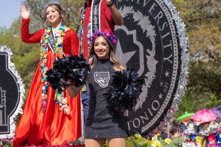 Photo for San Antonio, Texas, USA - April 8, 2022: The Battle of the Flowers Parade, Cheerleaders from Texas A&M University-San Antonio riding a float during the parade - Royalty Free Image