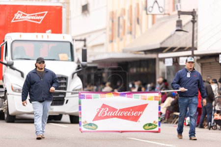 Photo for Brownsville, Texas, USA - February 26, 2022: Charro Days Grand International Parade, two men promoting Budweiser at the parade - Royalty Free Image