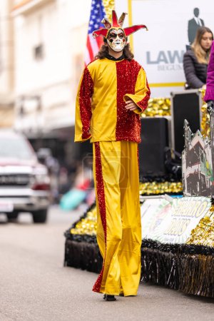 Photo for Brownsville, Texas, USA - February 26, 2022: Charro Days Grand International Parade, Man on stilts, wearing a carnival outfit at the parade - Royalty Free Image