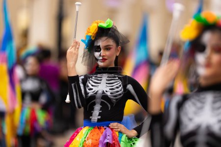 Photo for Matamoros, Tamaulipas, Mexico - November 1, 2022: Dia de los Muertos Parade, Cheerleaders from the Juan Jose De La Garza High School performing at the parade - Royalty Free Image