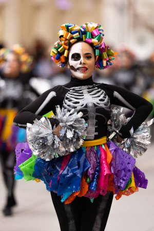 Photo for Matamoros, Tamaulipas, Mexico - November 1, 2022: Dia de los Muertos Parade, Cheerleaders from the Juan Jose De La Garza High School performing at the parade - Royalty Free Image