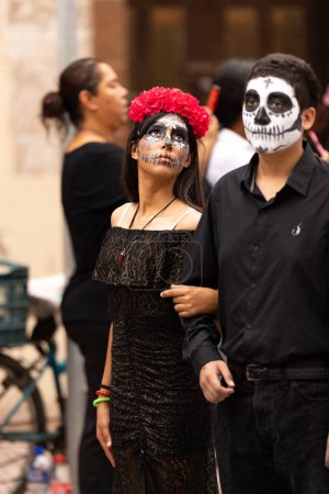Photo for Matamoros, Tamaulipas, Mexico - November 1, 2022: Dia de los Muertos Parade, young couple wearing a day of the dead outfire during the parade - Royalty Free Image