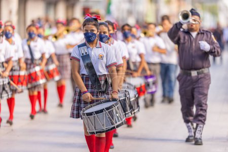 Photo for Matamoros, Tamaulipas, Mexico - September 16, 2022: Desfile 16 de Septiembre, Members of the Escuela Telesecundaria Jose Emilio Pacheco Berny Marching Band performing at the parade - Royalty Free Image