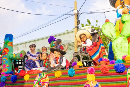 Photo for Matamoros, Tamaulipas, Mexico - February 25, 2023: Fiestas Mexicanas Parade, students from the Colegio Juvenal Rendon, wearing traditional clothing, riding a float at the parade - Royalty Free Image