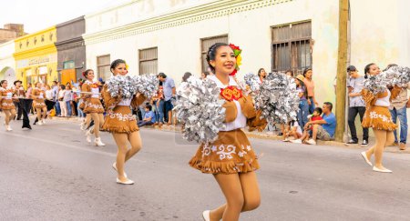 Photo for Matamoros, Tamaulipas, Mexico - February 25, 2023: Fiestas Mexicanas Parade, Cheerleaders wearing traditional clothing from the Ricardo Flores Magon High School performing at he parade - Royalty Free Image