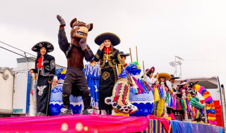 Photo for Matamoros, Tamaulipas, Mexico - February 25, 2023: Fiestas Mexicanas Parade, Students from the UNS High School, wearing traditional mexican clothing, riding a float at the parade - Royalty Free Image