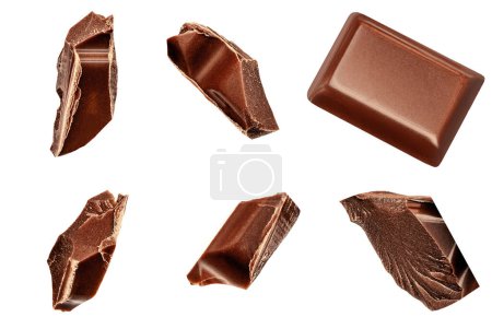 Foto de Chocolate chunks isolated on white background. Flying Chocolate pieces, shavings and cocoa crumbs Top view. - Imagen libre de derechos