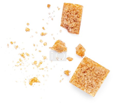 Photo for Brown sugar cubes isolated on white background. Thatched  sugar cubes with crumbs  Top view. Flat la - Royalty Free Image