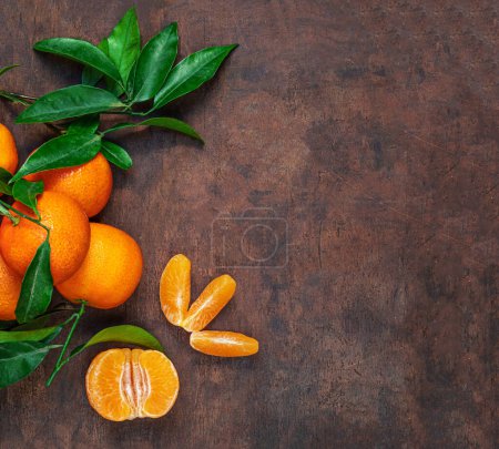 Photo for Fresh mandarin oranges fruit or tangerines with leaves on rustic wooden table, top view. Flat lay. Copyspace - Royalty Free Image