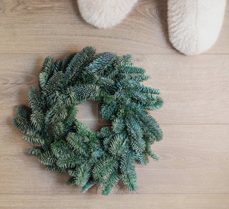 Photo for Cozy Christmas background with fir tree and home fluffy slippers top view. Top vie - Royalty Free Image