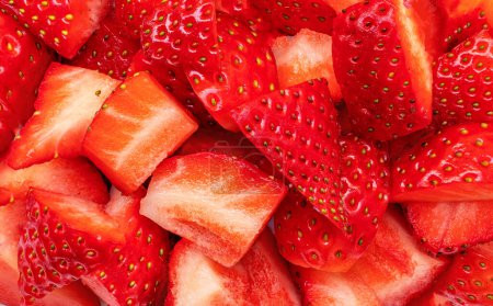 Photo for Chopped strawberry pieces textured background. Close up. Pattern - Royalty Free Image