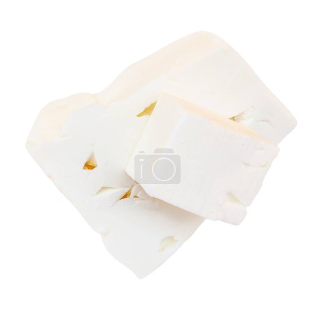 Foto de Queso feta sobre fondo blanco aislado, vista superior. Fesh trozos de queso feta griego cerrar u - Imagen libre de derechos